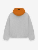 A grey sweatshirt adorned with vibrant orange text.