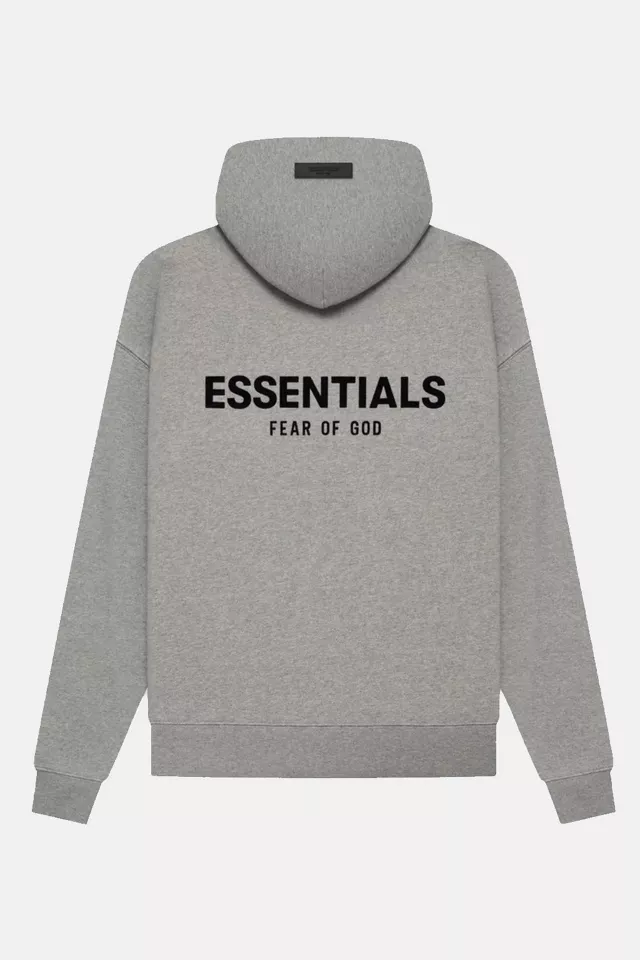 Grey sweatshirt featuring "Essentials Fear of God" text, representing a trendy urban essential hoodie style